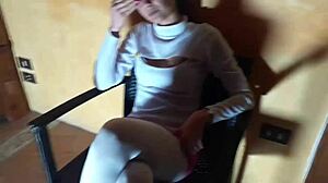 Latina milf lounges in pantyhose and heeled boots on chair