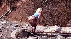 Big ass milf stretches fishnet pantyhose over beach pussy