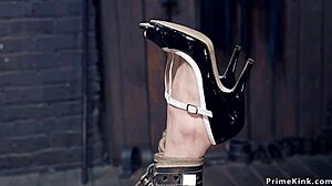 Blonde slave clamped in pins gets suspended choked whipped for rough gagging fuck