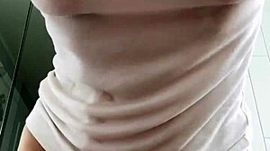 Baby oil drenches wet t-shirt clinging to oiled big clit pussy and natural tits